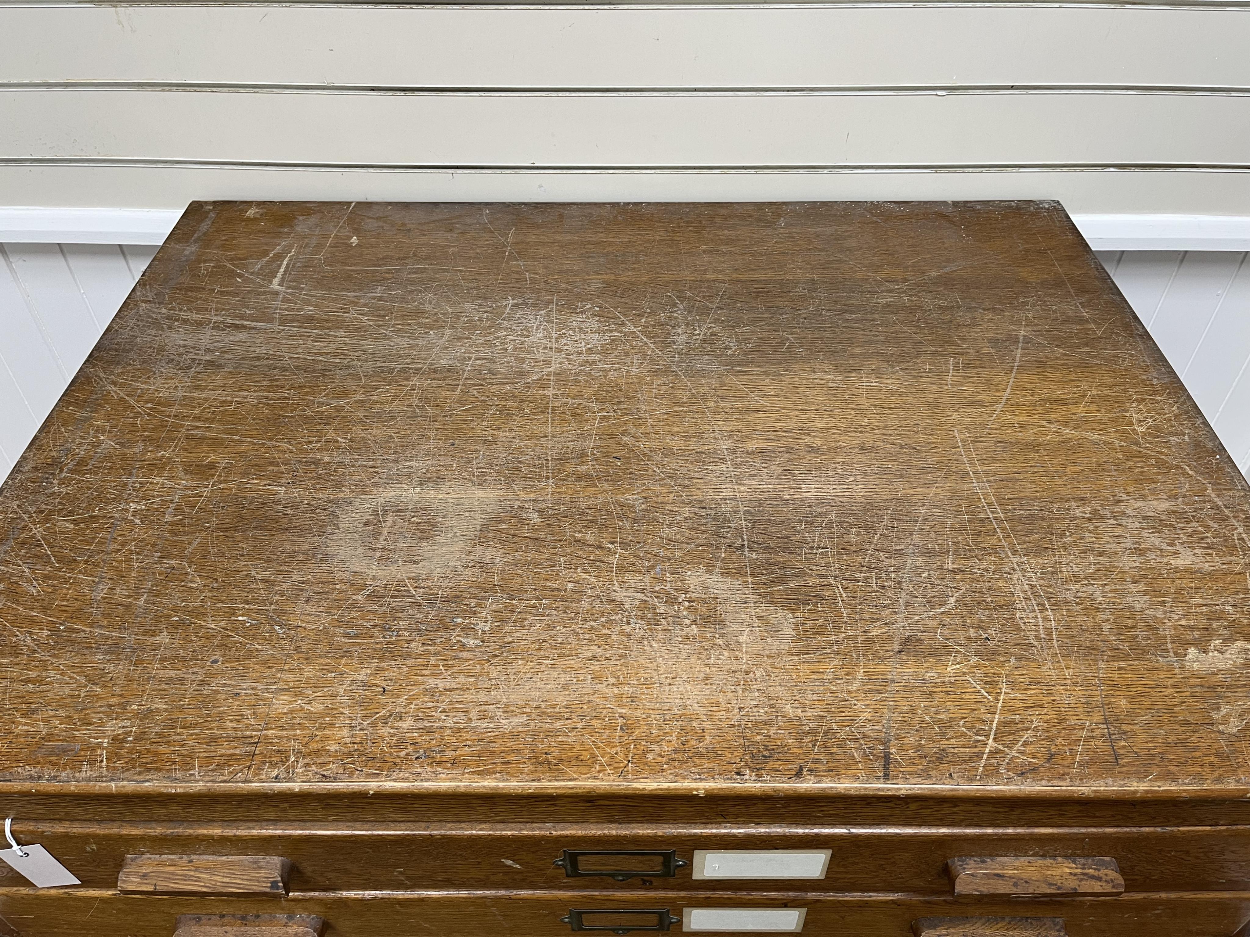 A 1930's light oak plan chest in two sections, width 113cm, depth 82cm, height 92cm